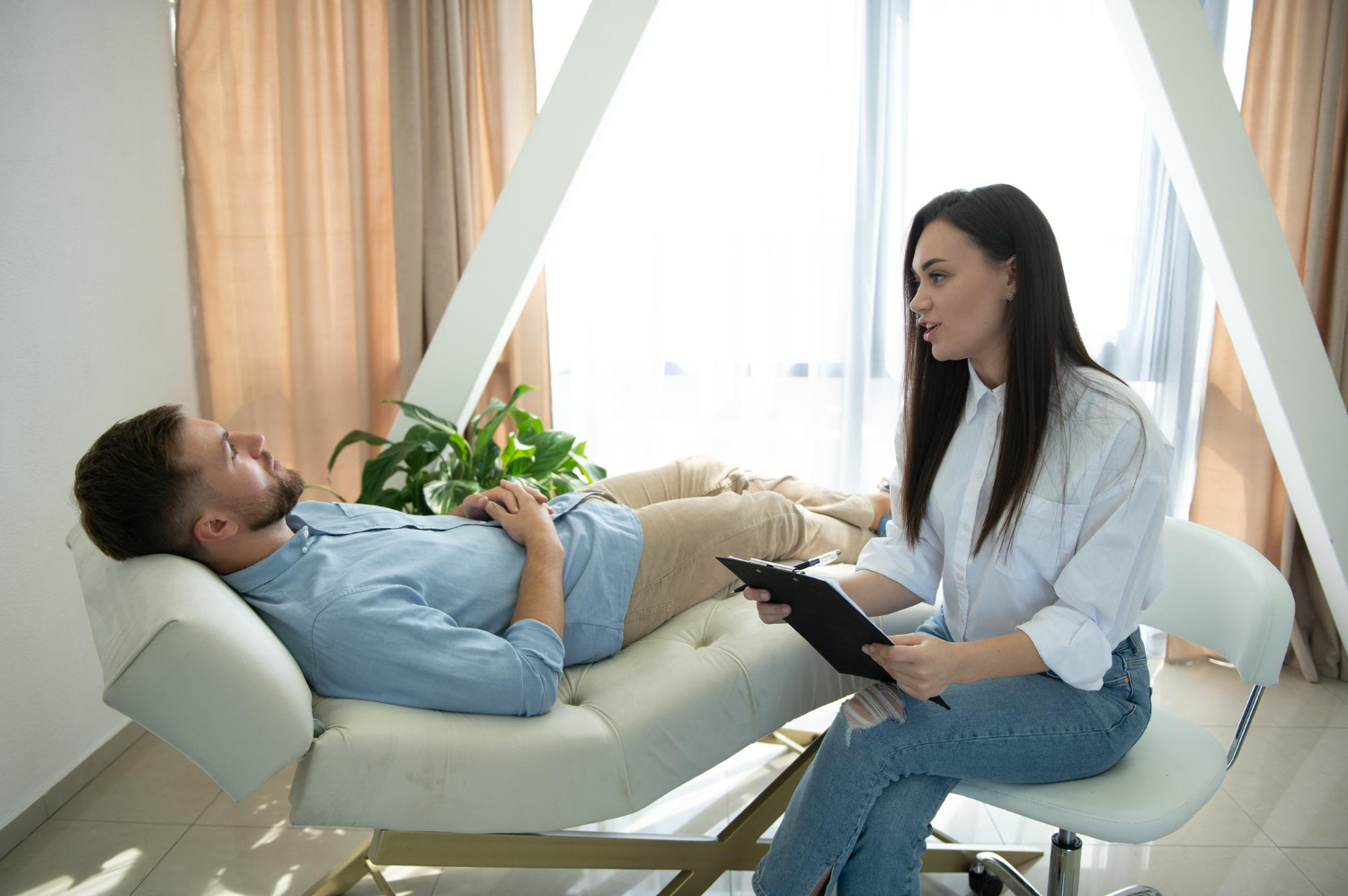 Clinical hypnotherapy session with a therapist guiding a relaxed client