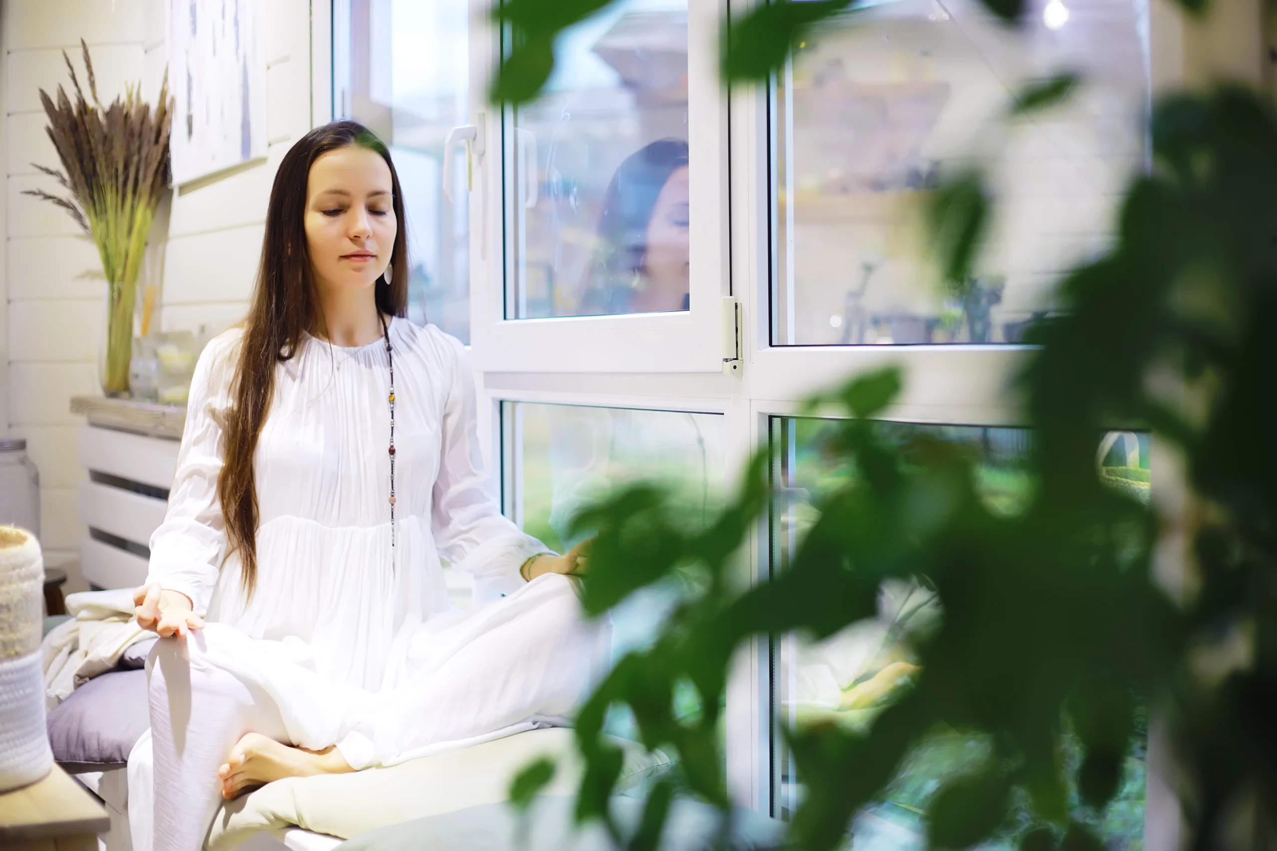 Woman practicing meditation for mental relaxation at home